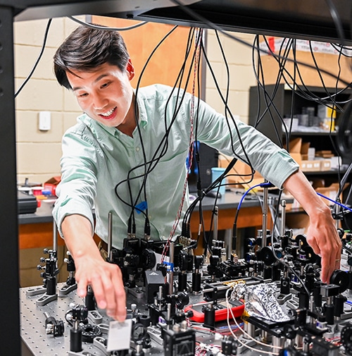 Professor Tian Li working on electrical panel