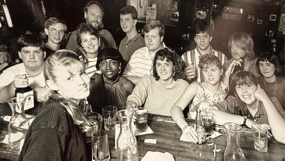 Group of students gathered around bar.