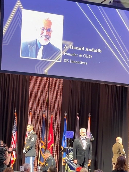 Honorees on stage with flags in the background