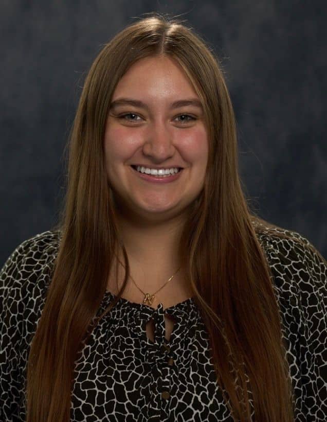 Headshot of Nicole Bravo Perez in front of a gray backdrop.