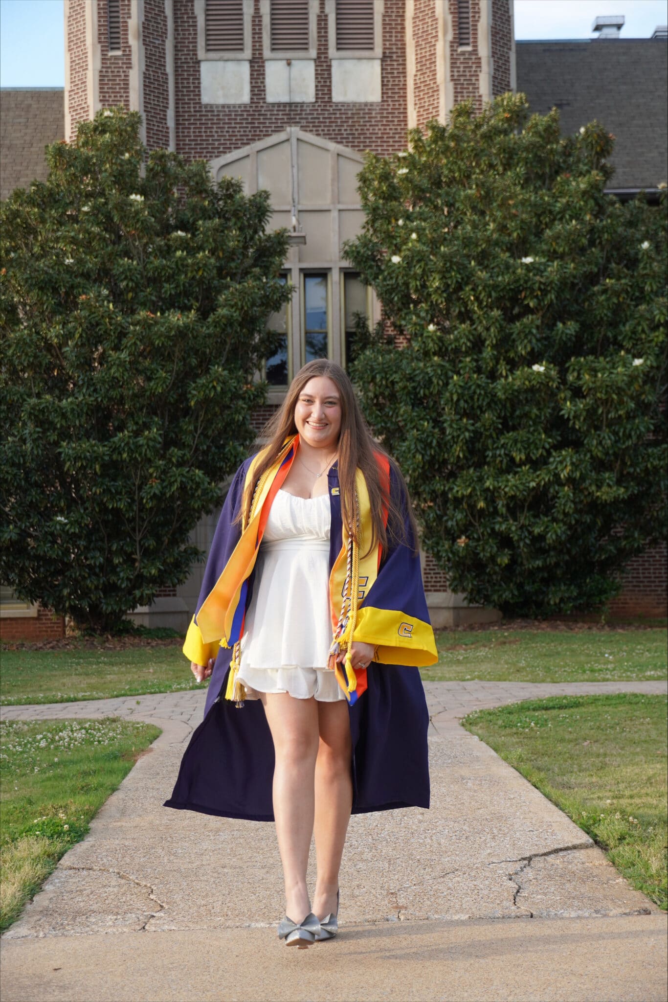 Nicole Perez in her graduation regalia on UTC's campus.
