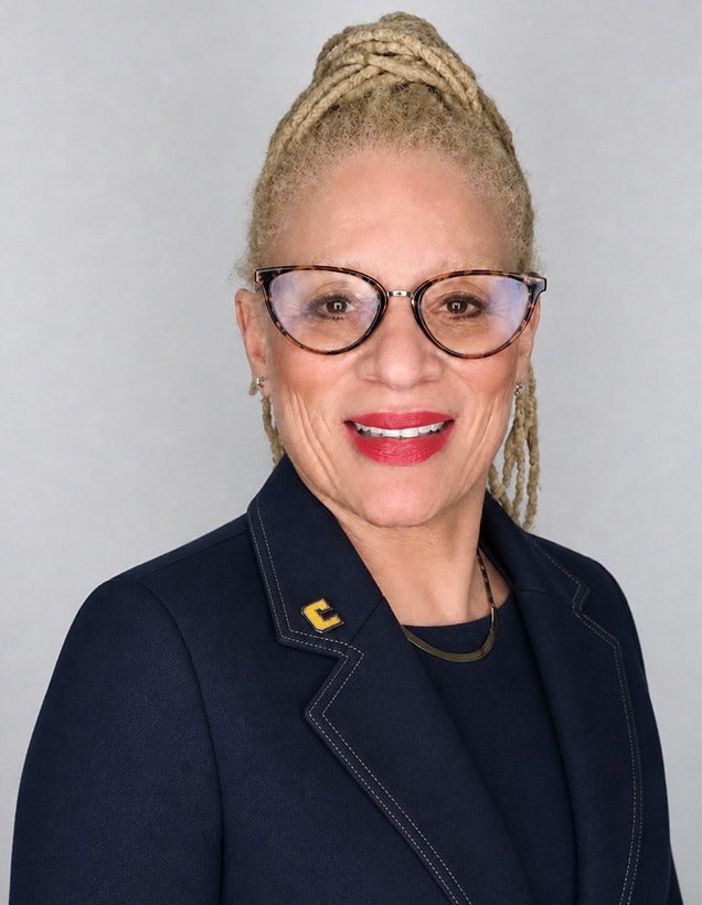 Leslie Valentine in front of a gray background.