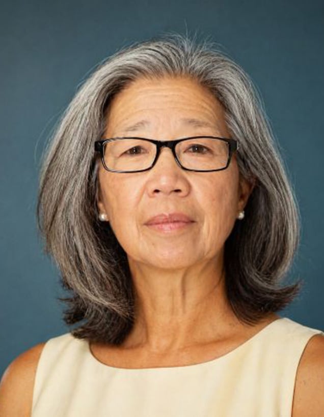 Lulu Copeland in front of a blue background.