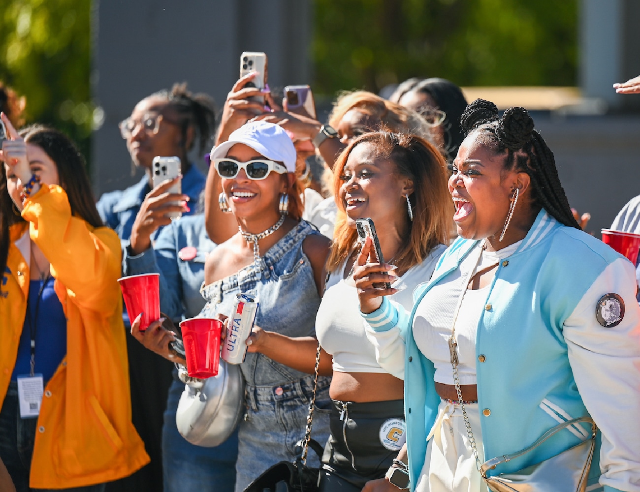 Alumni cheer on the UTC Mocs at they walk to Finley Stadium.