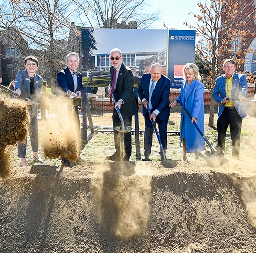 Gary Rollins and a group of people shoveling dirt at the Rollins College of Business Groundbreaking.