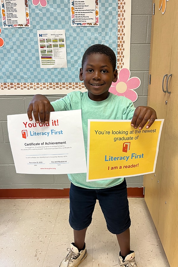 Student of the Literacy First Program holding signs.