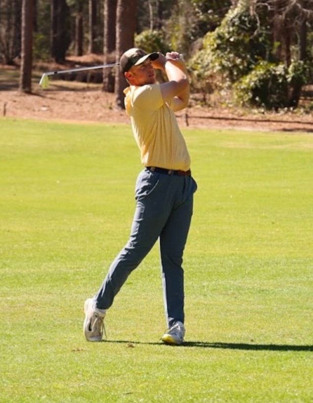 UTC alumnus Garrett Engle follows through on a golf shot during a round of golf.