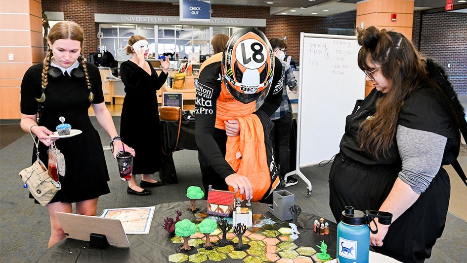 Students in costume playing a game in the library.